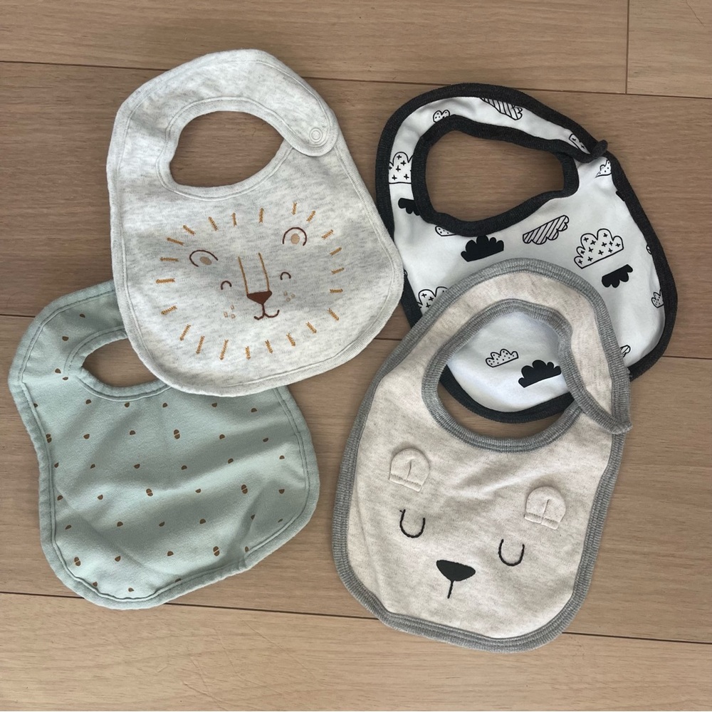 Never used! Set of four bibs, lion and bear, Carter’s and Cloud Island